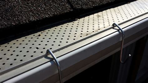 install christmas lights bottom of gutter metal bracket|gutter guard christmas light hooks.